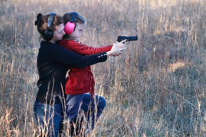 woman aiming a gun